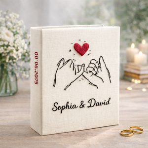 Personalized holding hands hand embroidered photo album with floral accents and custom names on linen cover