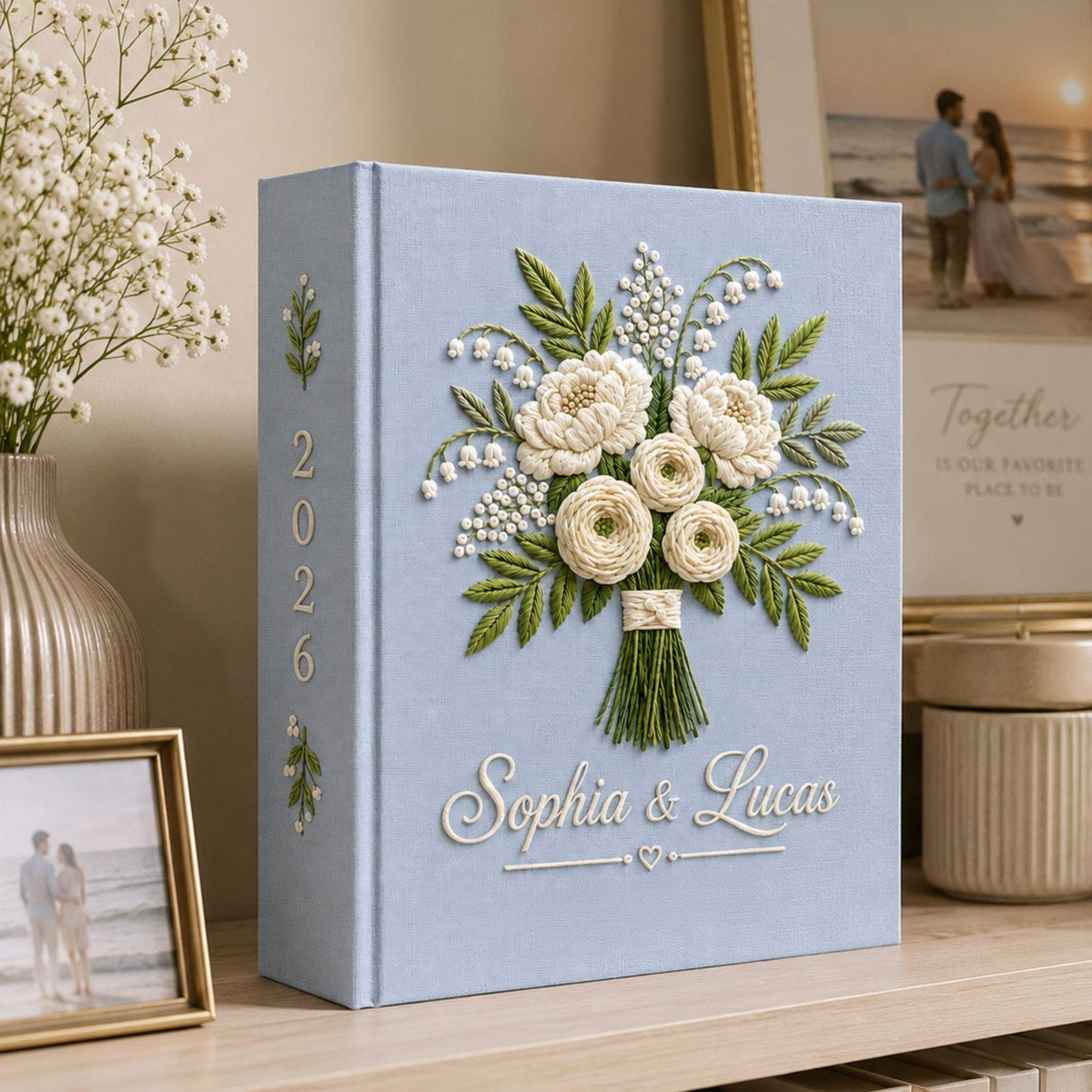 Personalized white floral bouquet hand embroidered photo album with custom names on blue linen wedding keepsake cover