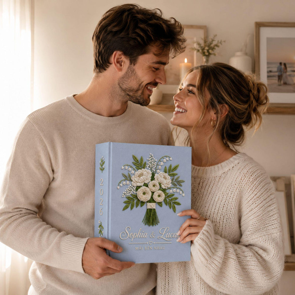 Personalized white floral bouquet hand embroidered photo album with custom names on blue linen wedding keepsake cover